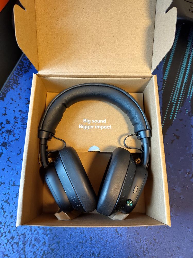 The headphones rest securely in the cardboard box.